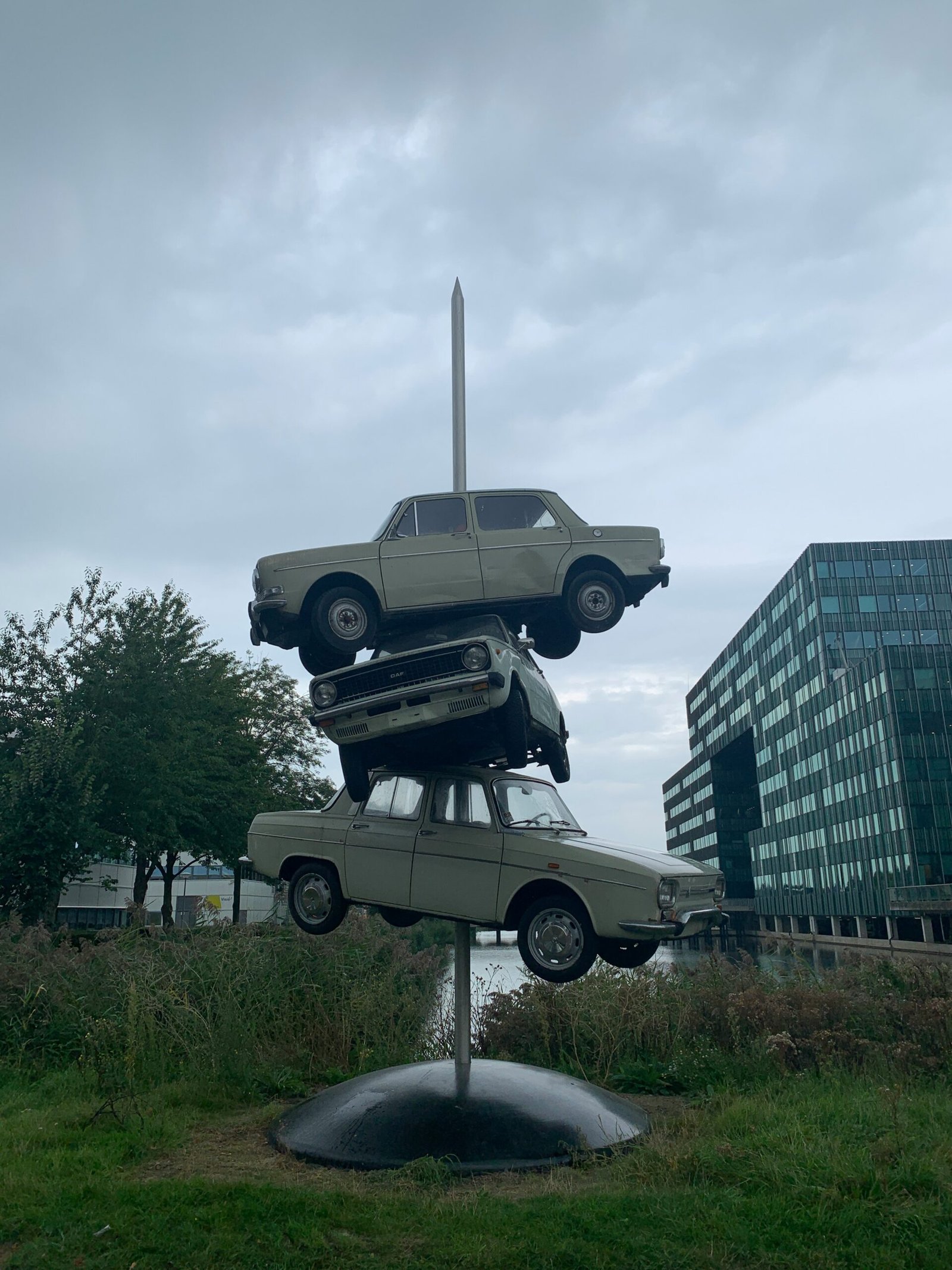 grey and black car statue near high rise building during daytime