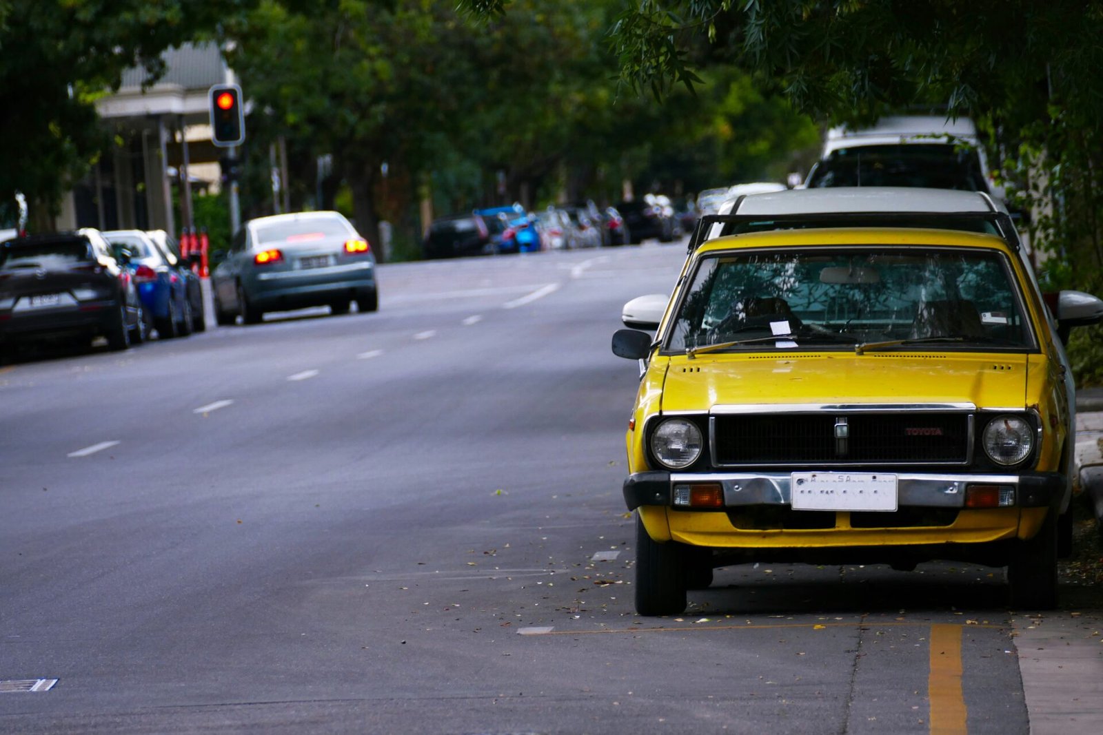 a yellow car parked on the side of the road